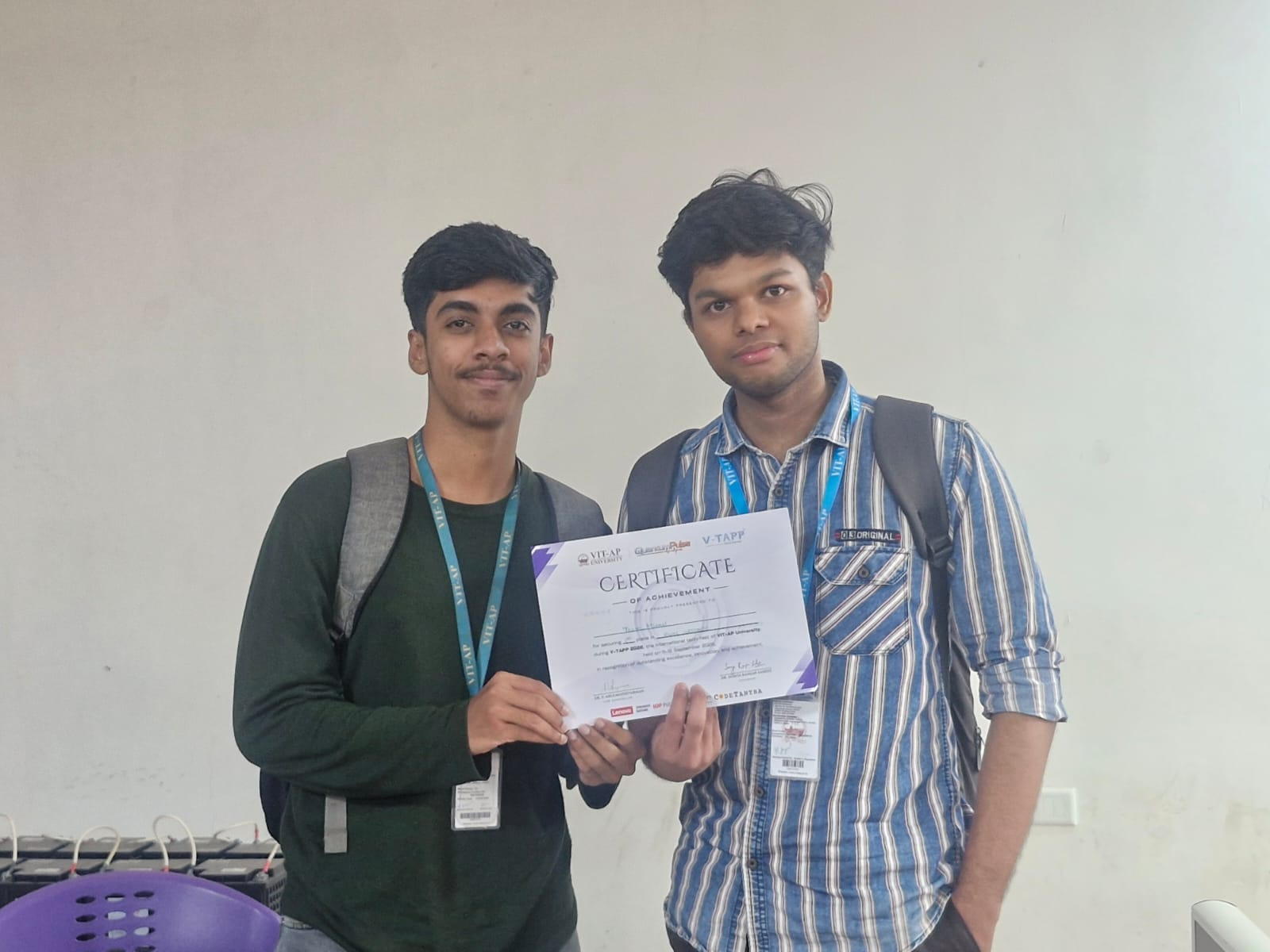 Two participants holding the PWN Grounds achievement certificate at V-TAPP 2026